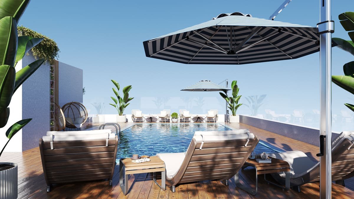 Rooftop pool at Estrella with sunbeds and umbrellas
